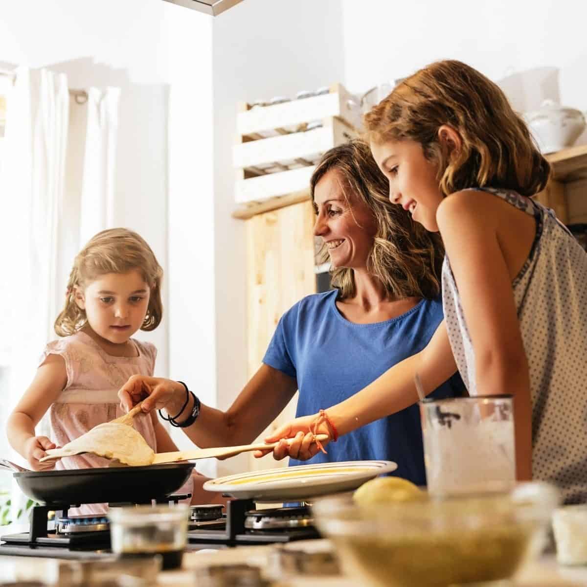 mother and daughters cooking together