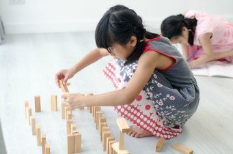 Girl playing with blocks - creative thinking