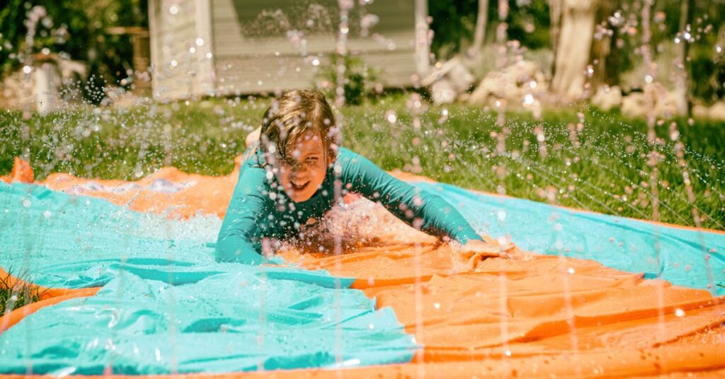 boy going down a slip and slide