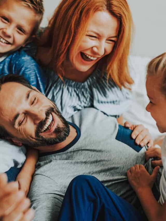 mother, father, son and daughter laughing together