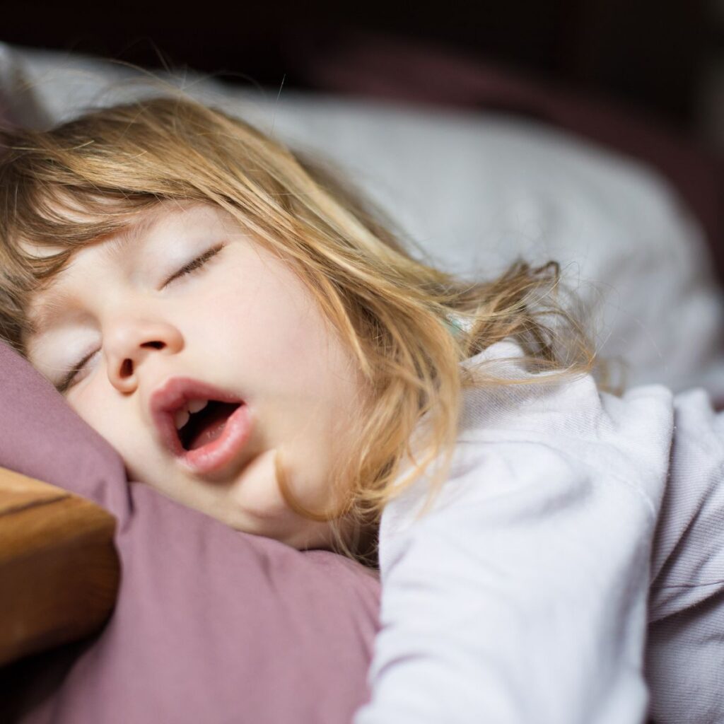 A little girl sleeping at bedtime with her mouth open