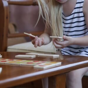 a girl playing a wooden working memory game