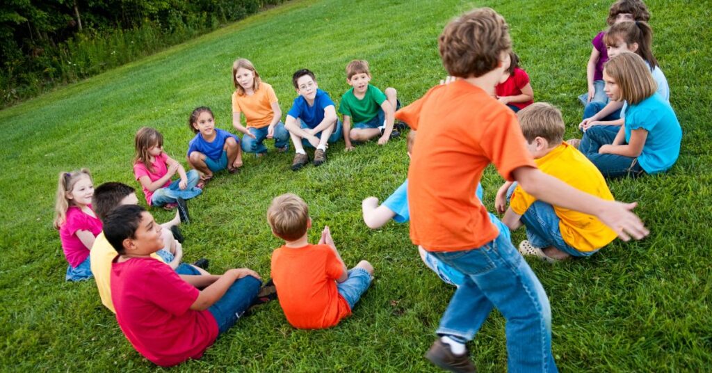 kids playing duck duck goose - one of the games that teach self control